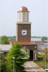 brick clock tower with a copper dome at daytime