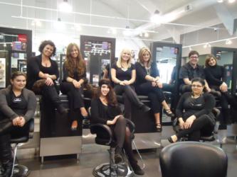 group of salon professionals smiling in a hair salon