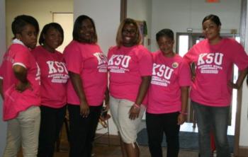 group of people in pink 'KSU' t-shirts