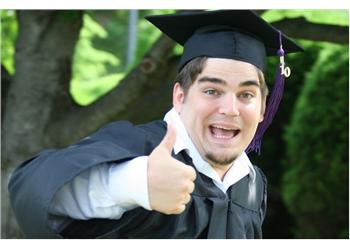 graduate giving thumbs up in cap and gown