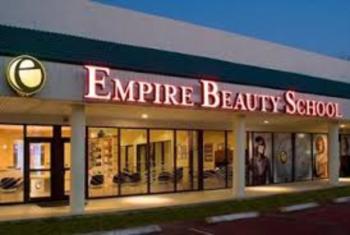 front view of 'Empire Beauty School' with lit signage