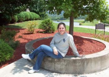 person sitting on campus ground