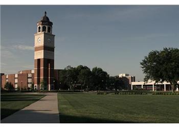 clock tower overlooking a landscaped university campus