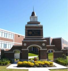 brick entrance with clock tower and landscaping