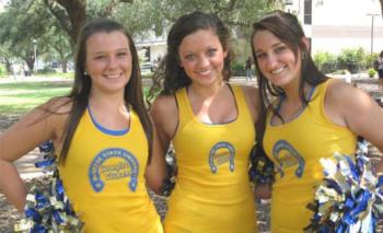 three cheerleaders posing with pom-poms