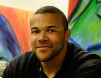 smiling man with artwork in background