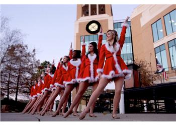 row of dancers in festive attire performing outdoors