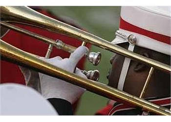 close-up of a musician playing trombone in uniform