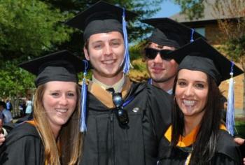 graduates smiling in caps and gowns