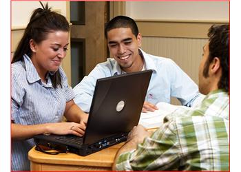 three students studying with a laptop