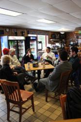 group of people having a discussion in a cafe setting