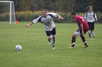 soccer player dribbling the ball on the field