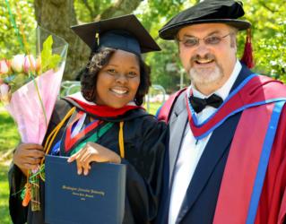 graduates smiling with diploma and flowers