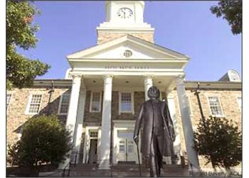 statue in front of building with columns