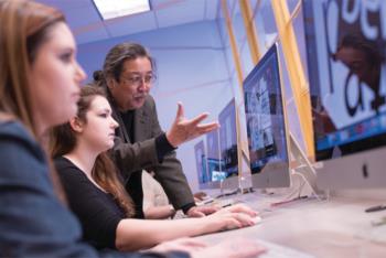 students learning with instructor at computer lab