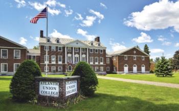 brick building with 'atlantic union college' sign and flag