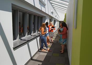 students chatting by hallway windows