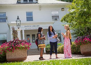 3 students in front of hatch library