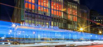 lit building facade at night with 'berklee college of music' sign