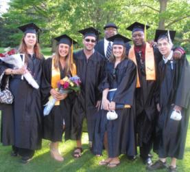 group of graduates smiling outdoors