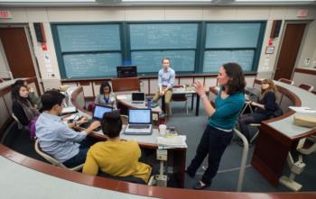 students in a classroom discussion with a lecturer