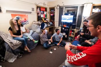 students playing cards in a dorm room