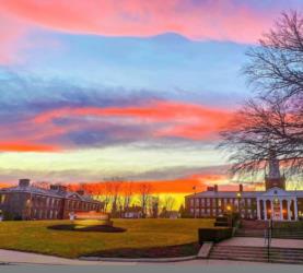 sunset behind campus buildings with vibrant sky