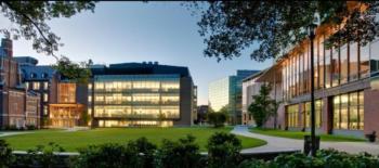 modern campus buildings with lit windows at dusk