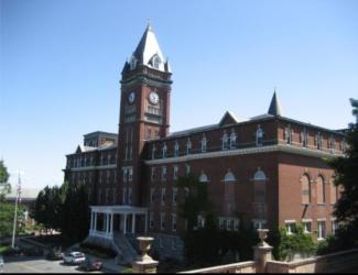 historic brick building with clock tower under blue sky