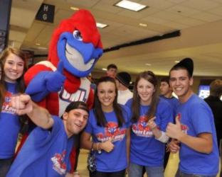 group of students posing with a blue mascot