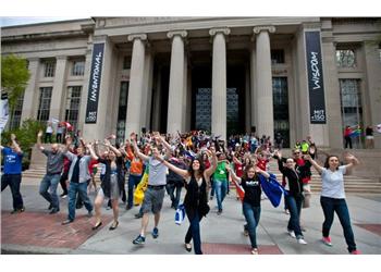 students posing in front of mit building