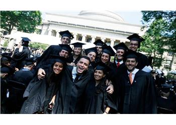 group of graduates smiling at mit ceremony