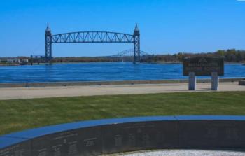 vertical lift bridge over river with clear blue sky