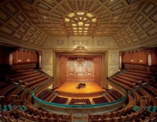 interior of an ornate auditorium with a grand piano on stage