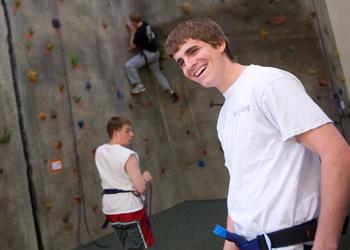 students rock climbing indoors