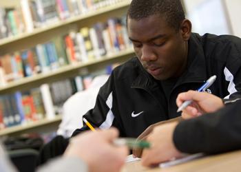 student taking notes in class