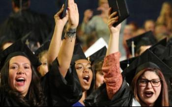 graduates in caps and gowns cheering