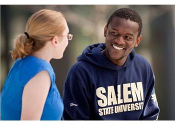 two students conversing, one in 'salem state university' hoodie