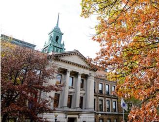 historic building with spire behind autumn foliage