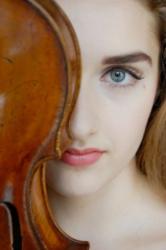 close-up of a woman beside a violin