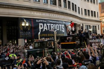 crowd watching a parade with banners