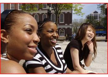 three students smiling outdoors