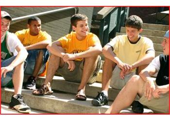 students sitting on steps outside