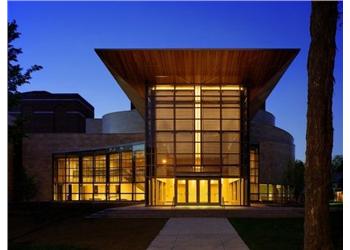 night view of a modern building with illuminated windows