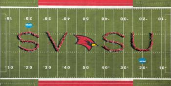 people forming 'SVSU' on a football field