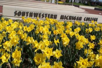 daffodils in front of 'southwestern michigan college' sign