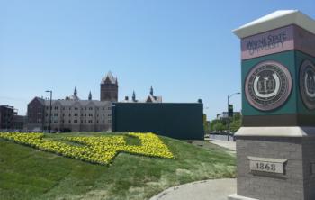 building with 'Wayne State University' logo and yellow flowers