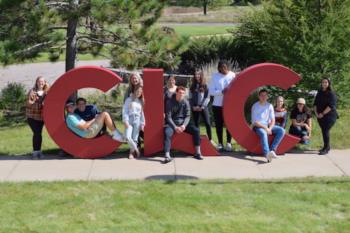 students posing with large 'clc' letters on campus