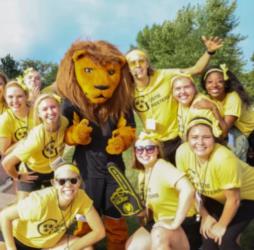 group of students in yellow shirts with mascot