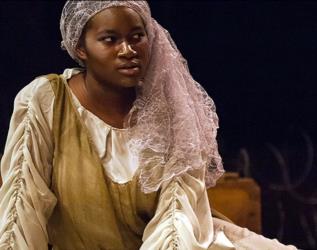 actress in period costume on stage